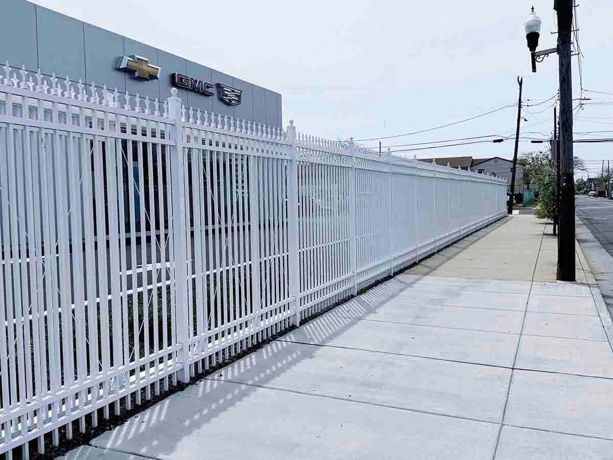White Ornamental Iron Fence Along Commercial Sidewalk