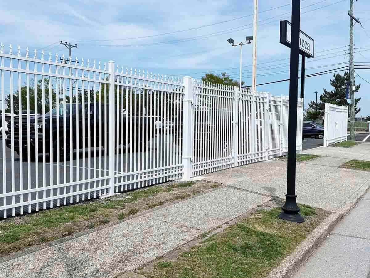 White Ornamental Iron Fence Installed at Auto Dealership